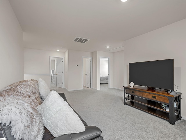 living area with recessed lighting, baseboards, visible vents, and light colored carpet