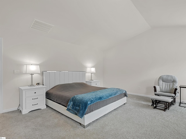 bedroom featuring light carpet, vaulted ceiling, visible vents, and baseboards