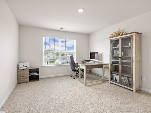 carpeted home office featuring baseboards and visible vents