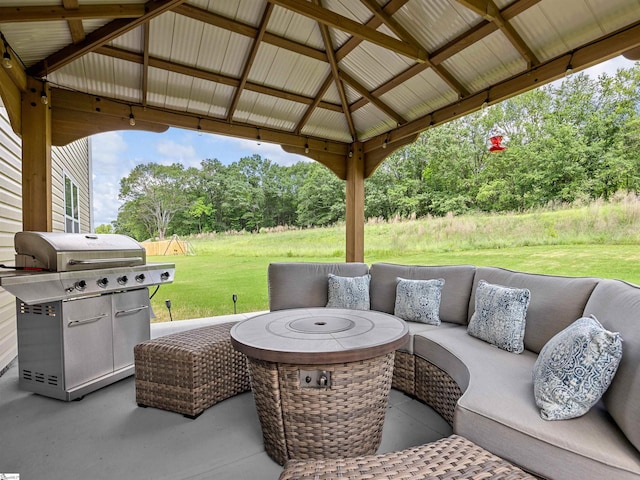 view of patio with an outdoor living space with a fire pit, grilling area, and a gazebo