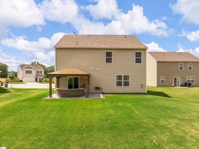 back of property featuring a patio area, a lawn, and a gazebo