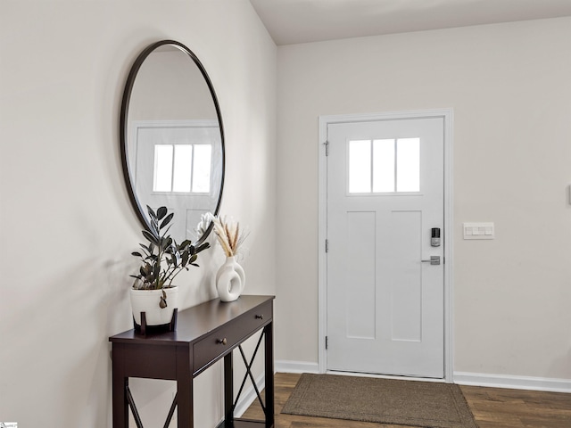 foyer entrance featuring dark wood-style floors and baseboards