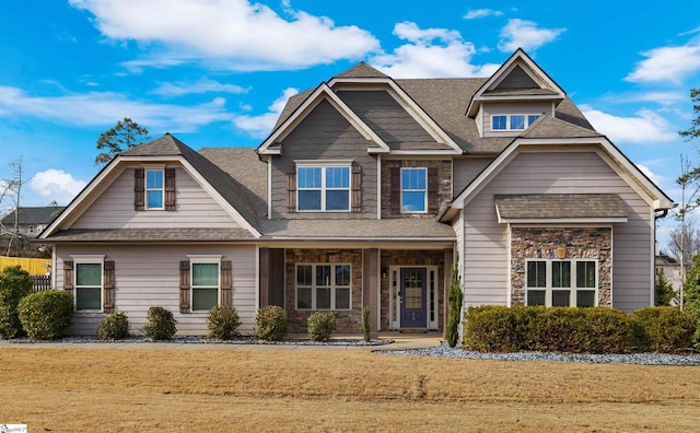 craftsman-style home featuring a porch and a front yard