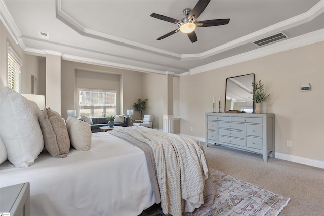 bedroom featuring a raised ceiling, crown molding, carpet, and ceiling fan