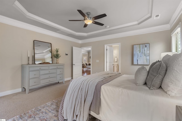 bedroom with a tray ceiling, ornamental molding, light colored carpet, and ceiling fan