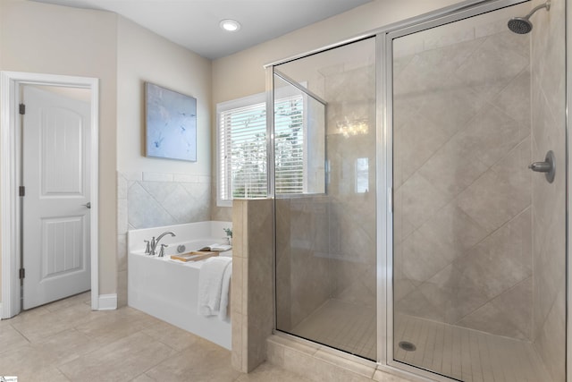 bathroom with tile patterned floors and separate shower and tub