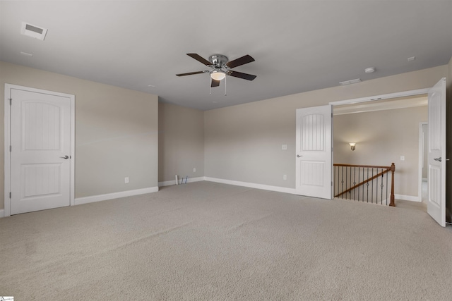 carpeted spare room with ceiling fan