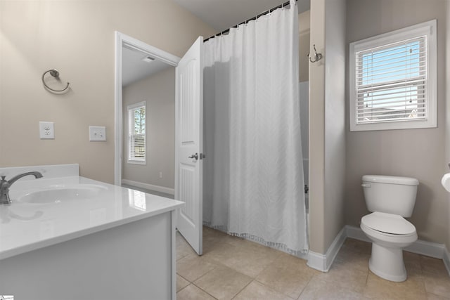 bathroom with vanity, tile patterned floors, toilet, and walk in shower