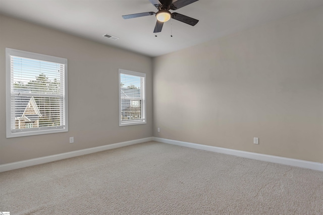 empty room featuring ceiling fan and carpet floors