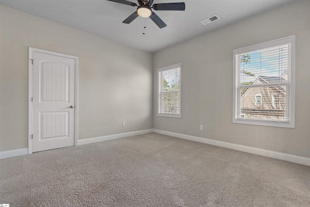 empty room featuring carpet floors and ceiling fan