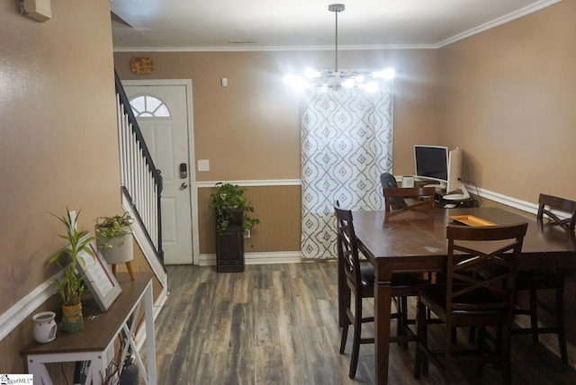 dining room with ornamental molding, a notable chandelier, and dark hardwood / wood-style flooring