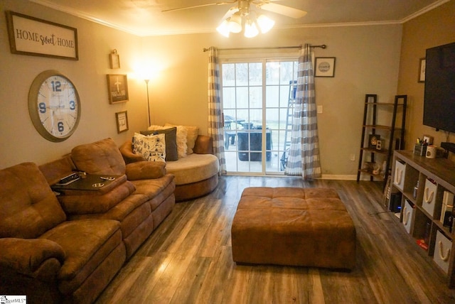 living room with hardwood / wood-style floors, ornamental molding, and ceiling fan