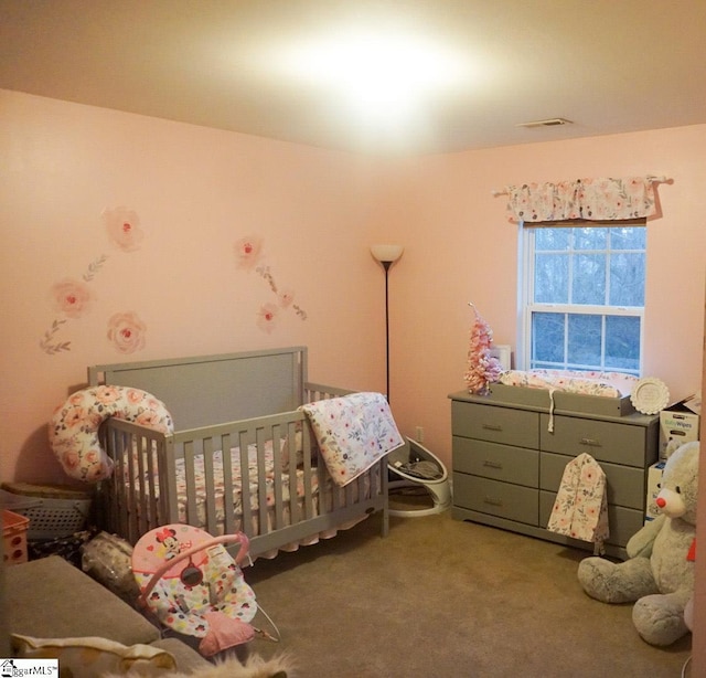 carpeted bedroom with a nursery area