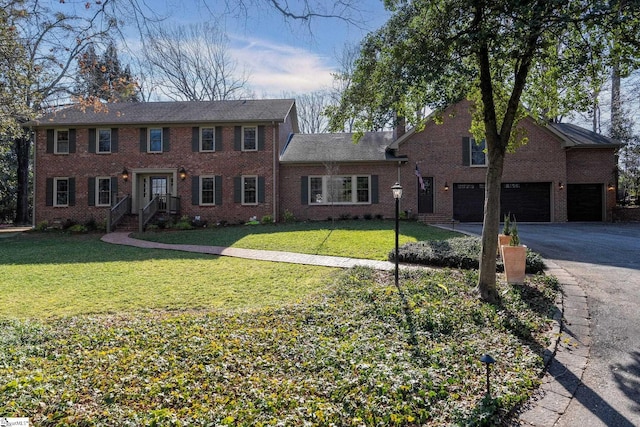 view of front of house with a garage and a front lawn