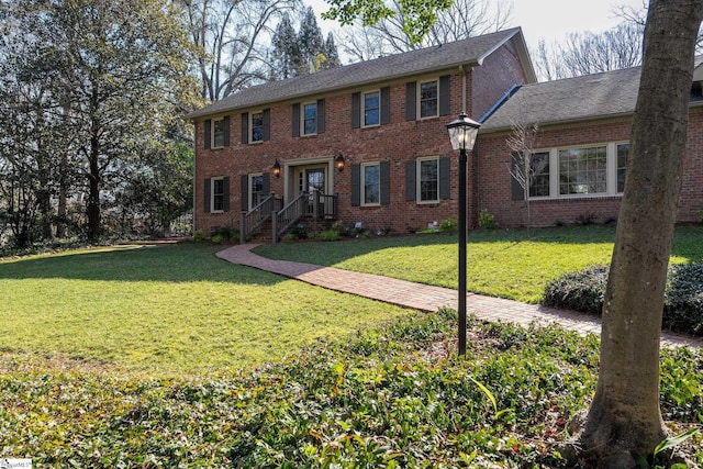 colonial inspired home with a front lawn