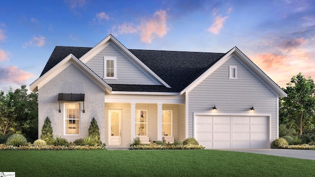 view of front facade featuring a garage and a yard