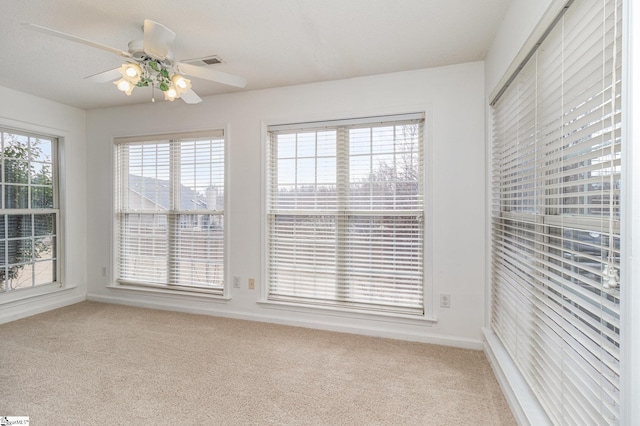 spare room with carpet flooring and ceiling fan