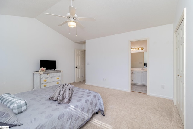 bedroom with ceiling fan, light colored carpet, ensuite bathroom, and vaulted ceiling