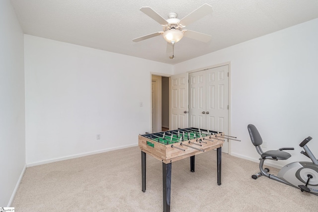 playroom with ceiling fan, carpet floors, and a textured ceiling