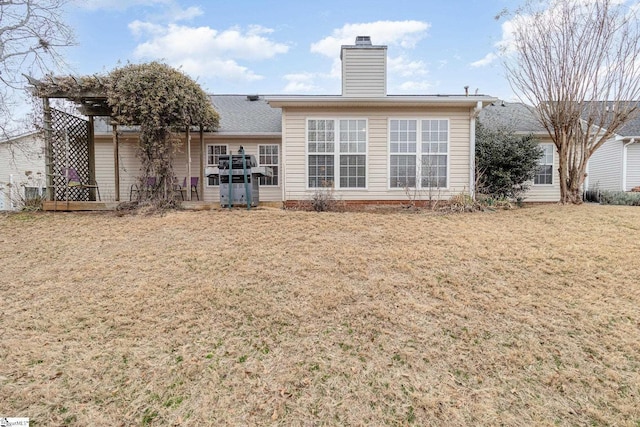 back of house with a lawn