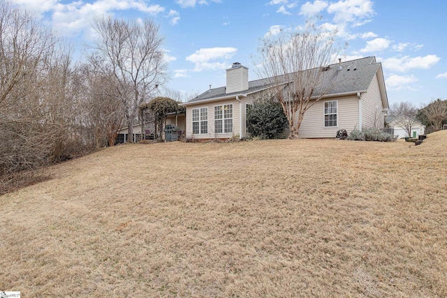 rear view of house with a yard