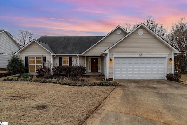 ranch-style house with a garage and a yard