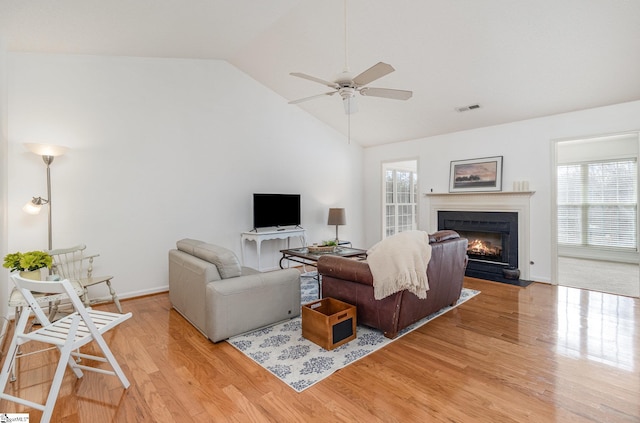 living room with lofted ceiling, light hardwood / wood-style floors, and ceiling fan