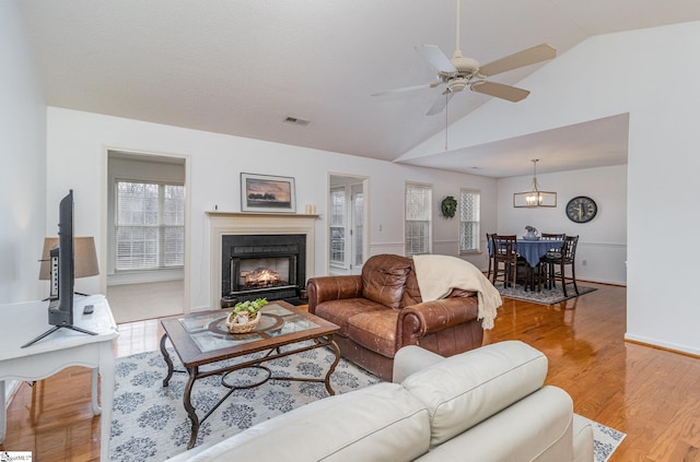 living room with lofted ceiling, light hardwood / wood-style flooring, and ceiling fan