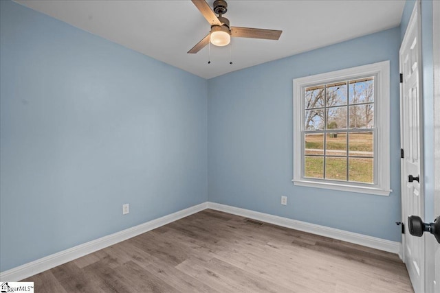 empty room with ceiling fan and light hardwood / wood-style floors