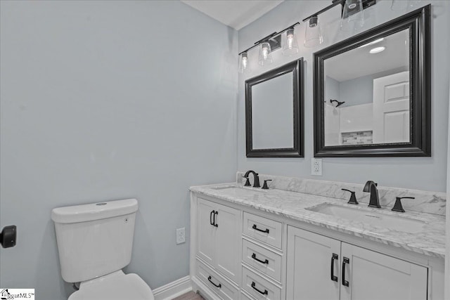 bathroom featuring vanity, toilet, and a shower