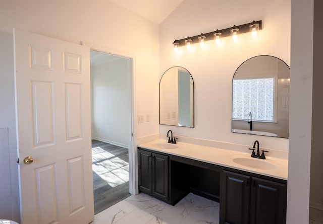 bathroom with lofted ceiling and vanity