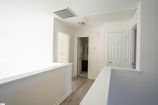 corridor featuring light hardwood / wood-style floors