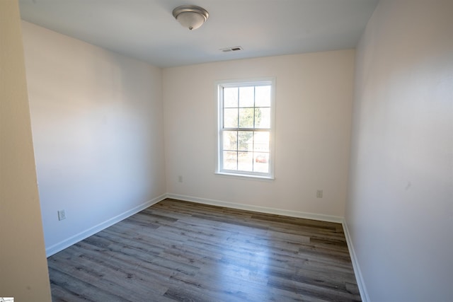 unfurnished room with dark hardwood / wood-style floors