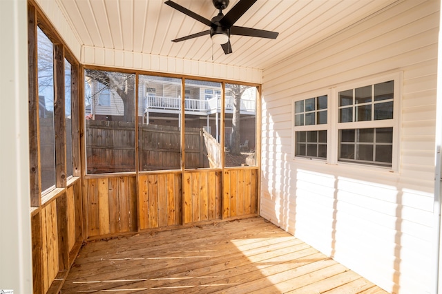 unfurnished sunroom with wooden ceiling and ceiling fan