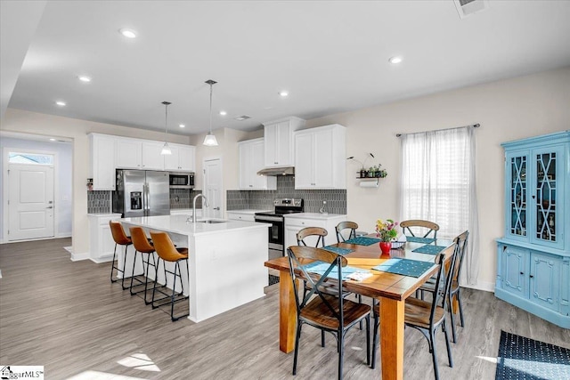 dining room featuring light hardwood / wood-style floors and sink