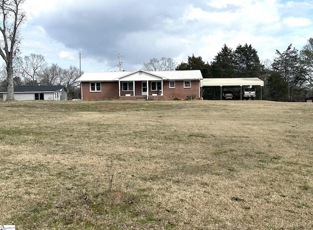 view of front of property featuring a carport, a front yard, and covered porch