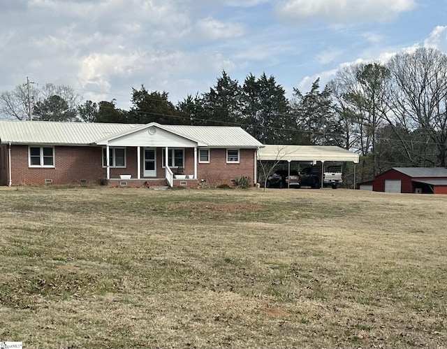 ranch-style home featuring a carport, covered porch, and a front yard