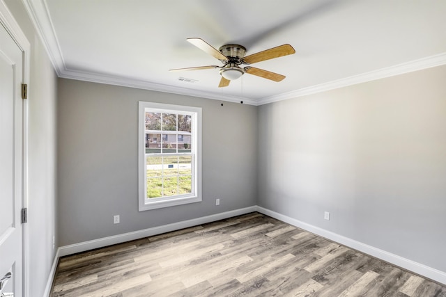 empty room featuring crown molding, ceiling fan, and light wood-type flooring