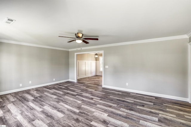 unfurnished room featuring dark wood-type flooring, ceiling fan, and crown molding