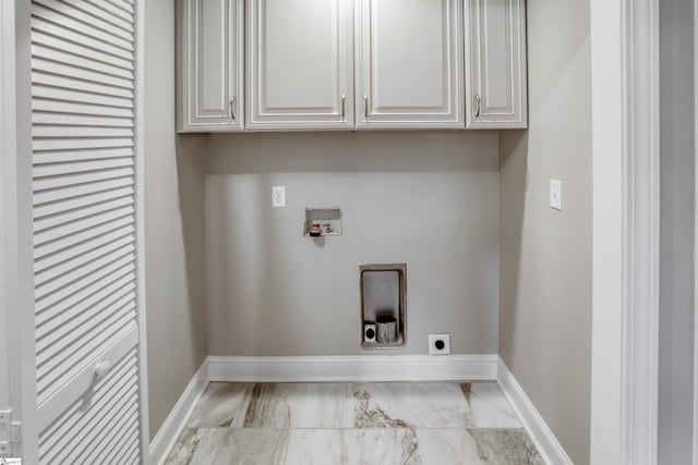 laundry area with cabinets, hookup for a washing machine, and hookup for an electric dryer