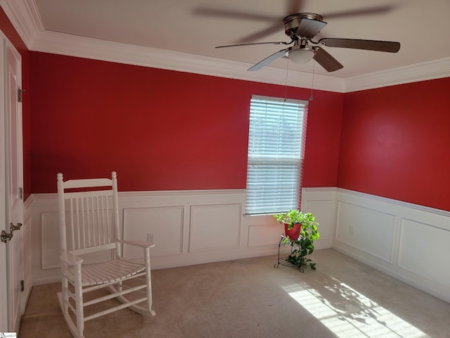 interior space featuring crown molding, light colored carpet, and ceiling fan