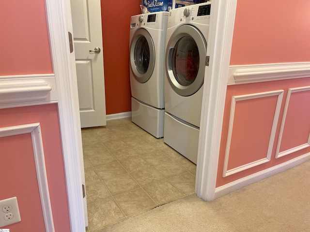 laundry area featuring washer and dryer and light tile patterned floors