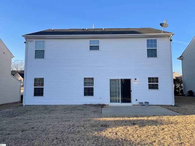 rear view of property featuring a patio area