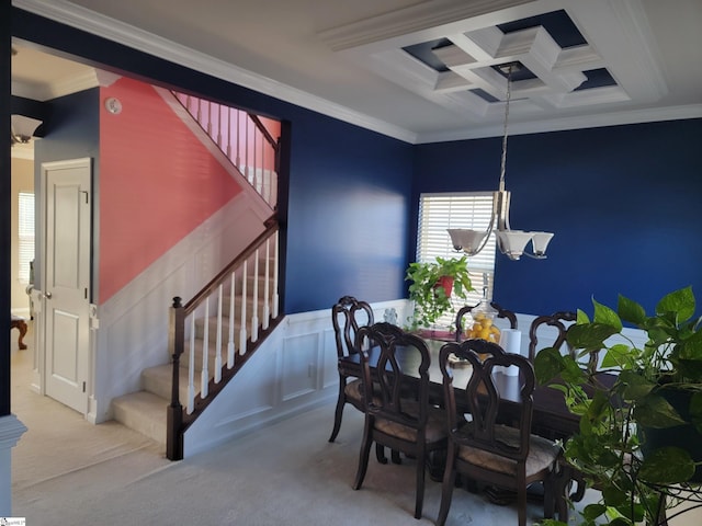 carpeted dining area with beam ceiling, crown molding, coffered ceiling, and an inviting chandelier