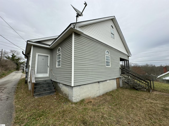 view of side of home featuring a yard