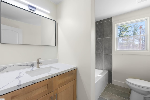 full bathroom with tile patterned floors, vanity, toilet, and washtub / shower combination