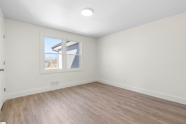 empty room with light hardwood / wood-style flooring