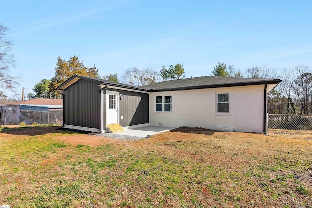 rear view of house featuring a yard and a patio area