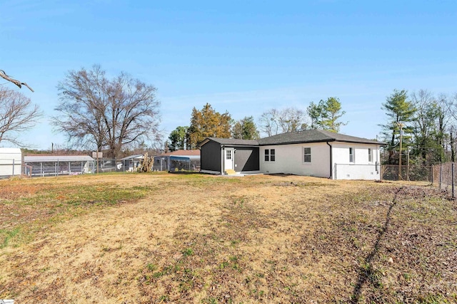 rear view of house with a lawn