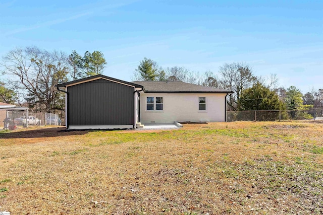 rear view of property with a yard and a patio area